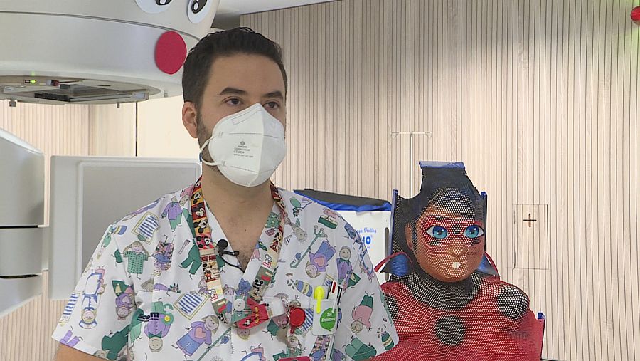 Enfermero pediátrico que ilustra las máscaras  radiotérapicas