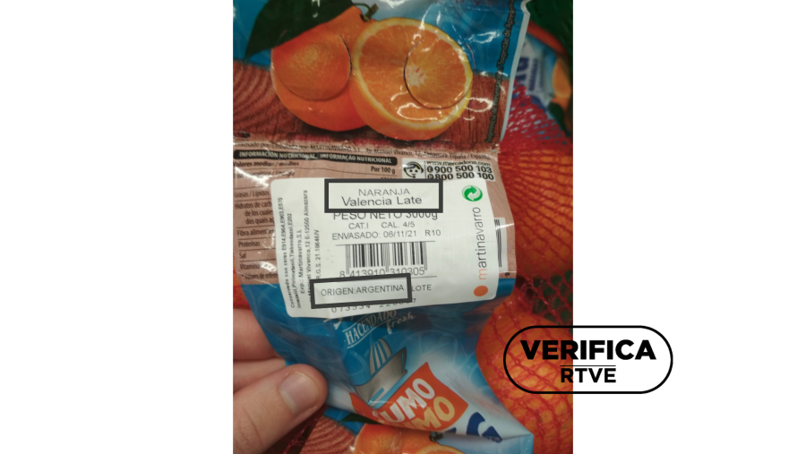 Fotografía de una etiqueta de Mercadona en una malla de naranjas de procedencia argentina de la variedad Valencia Late, con el sello 'VerificaRTVE' en negro