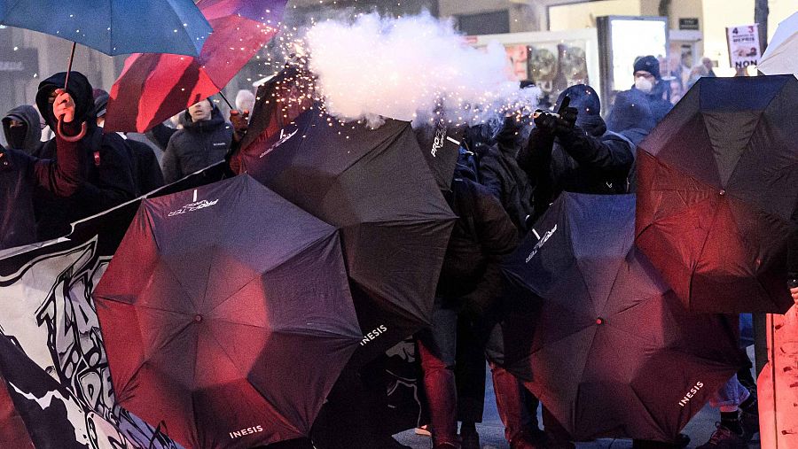 Los manifestantes disparan fuegos artificiales a los agentes de policía