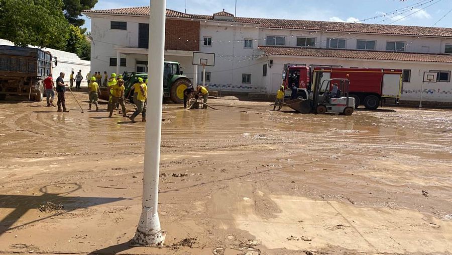 Un vecino de Belmonte, Sinesio, ayuda con su tractor a limpiar el patio del colegio