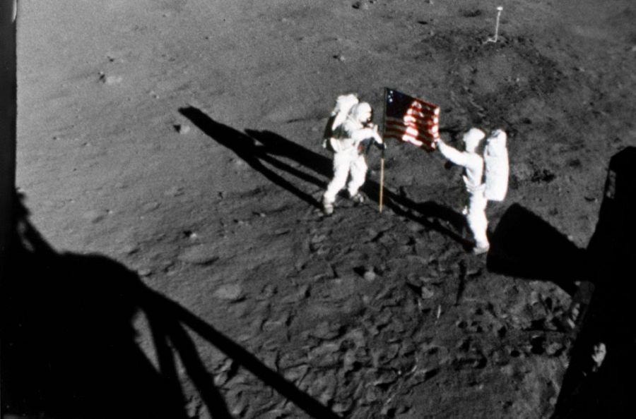 20 Jul 1969- Astronaut Neil A. Armstrong, stands on the left at the flag's staff. Astronaut Edwin E. Aldrin Jr., also pictured. Pic taken by the 16mm Data Acquisition Camera (DAC) mounted in the LM - deploy flag.