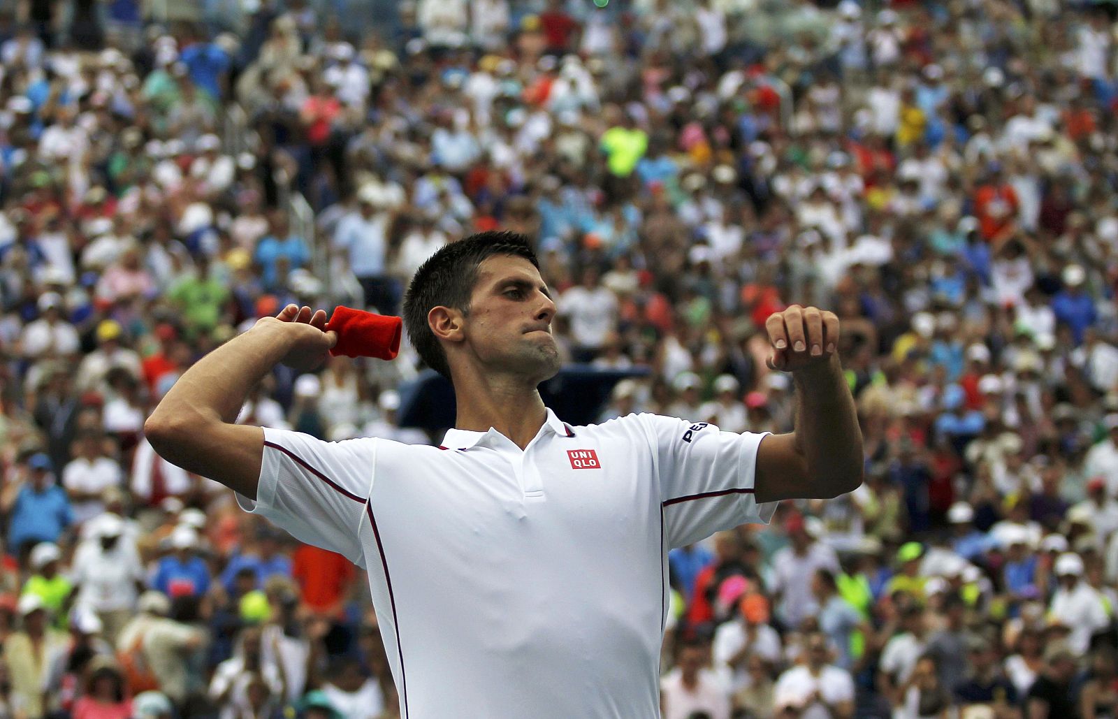 Novak Djokovic of Serbia throws his wrist band into the crowd after defeating to Philipp Kohlschreiber of Germany at the 2014 U.S. Open tennis tournament in New York