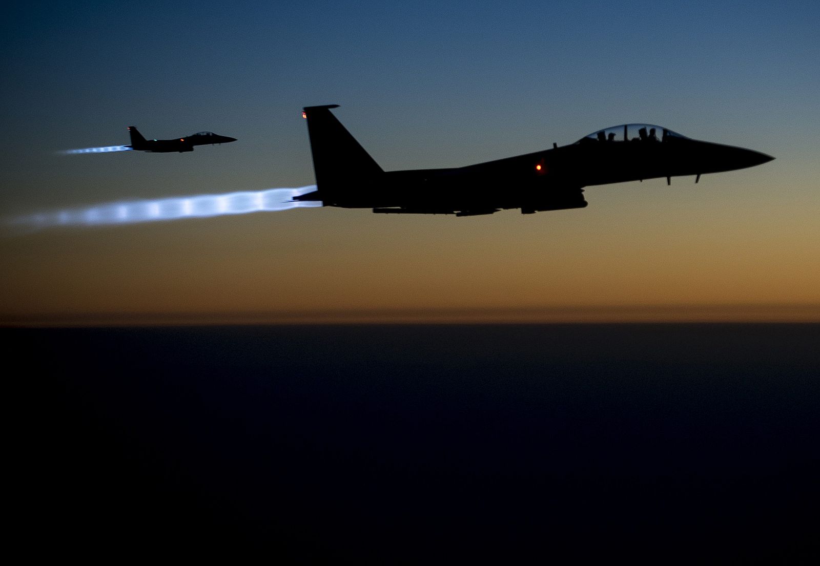 A pair of U.S. Air Force F-15E Strike Eagles fly over northern Iraq