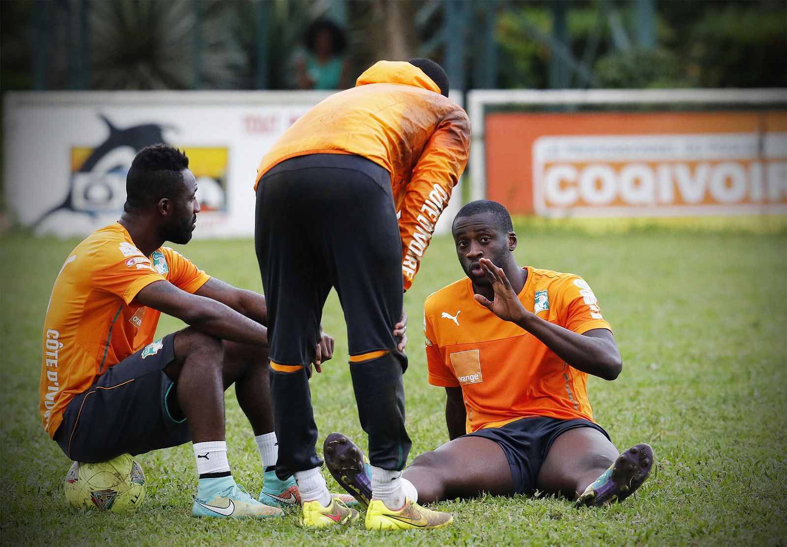 Ivory Coast's national soccer players Toure, Copa and Siaka chat after a training session in Abidjan
