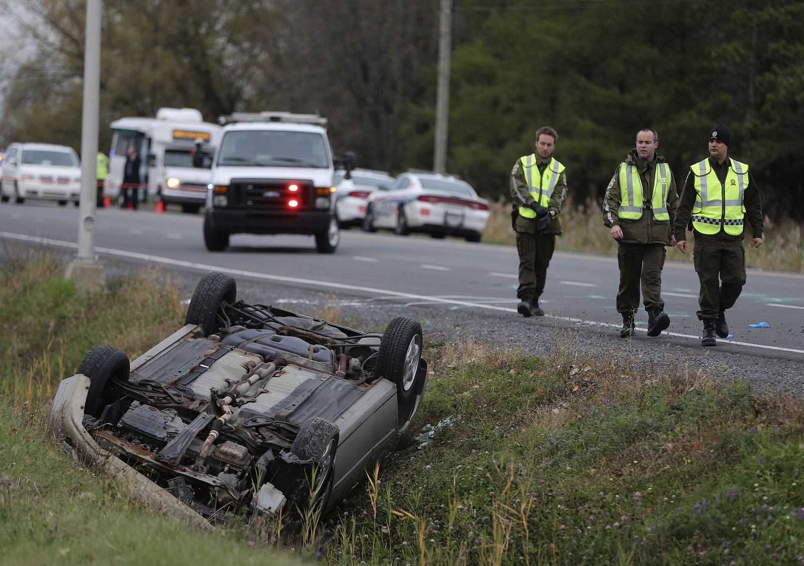 Surete du Quebec officer investigates an overturned vehicle in Saint-Jean-sur-Richelieu