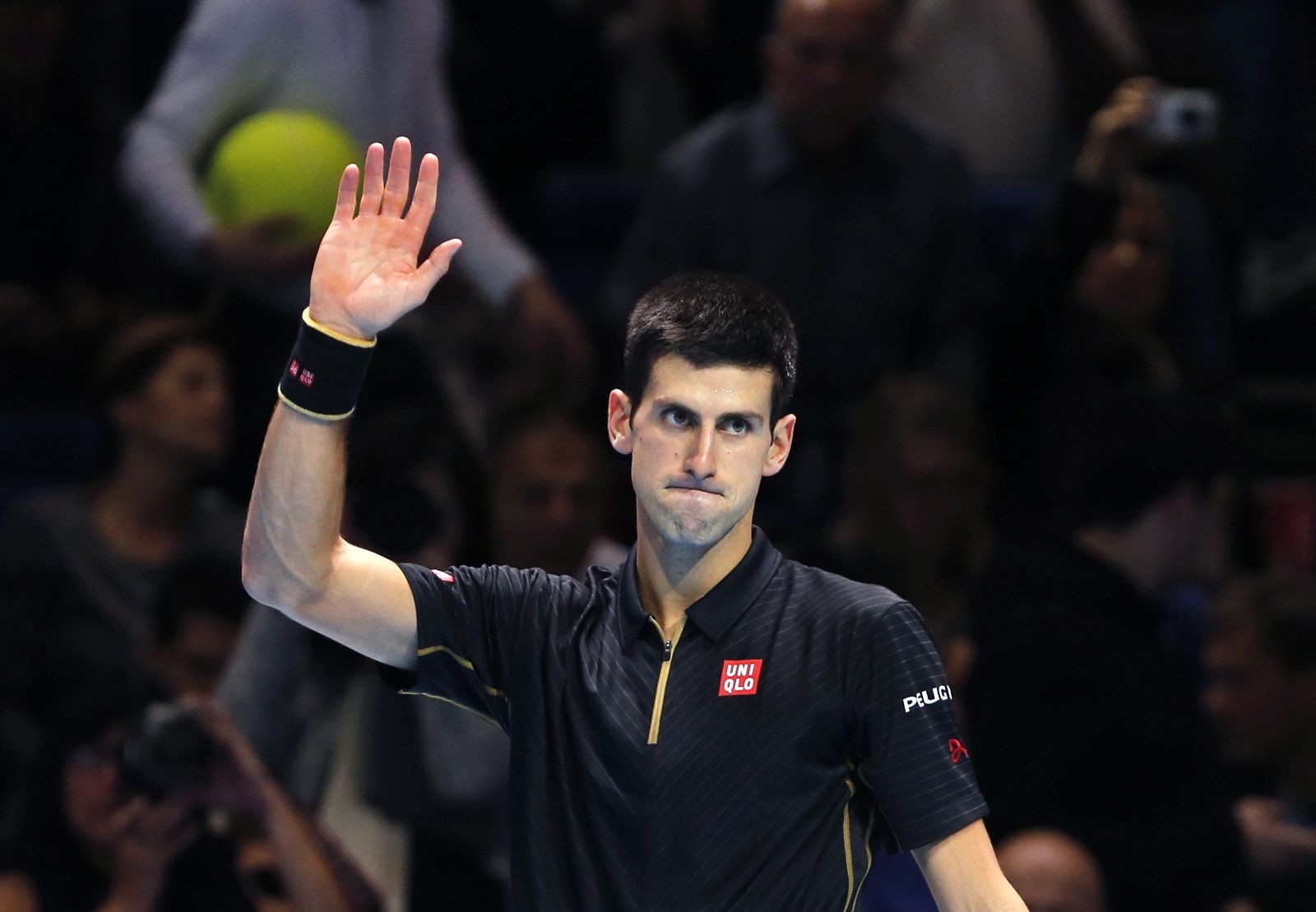 Novak Djokovic of Serbia waves after defeating Andy Murray of Britain during an exhibition match at the ATP World Tour Finals at the O2 in London