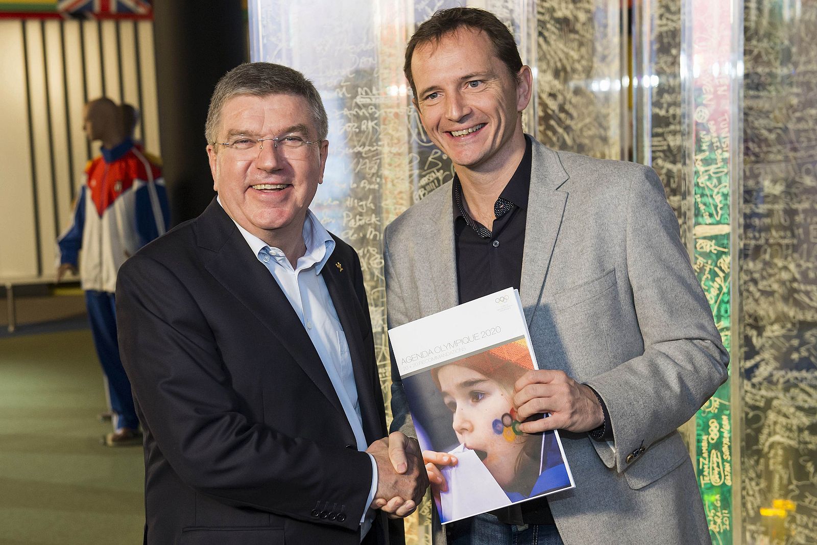 IOC President Bach shakes hands with table tennis player Saive of Belgium before a round table with athletes from around the world to present the new Olympic Agenda 2020 discussions at the Olympic Museum in Lausanne