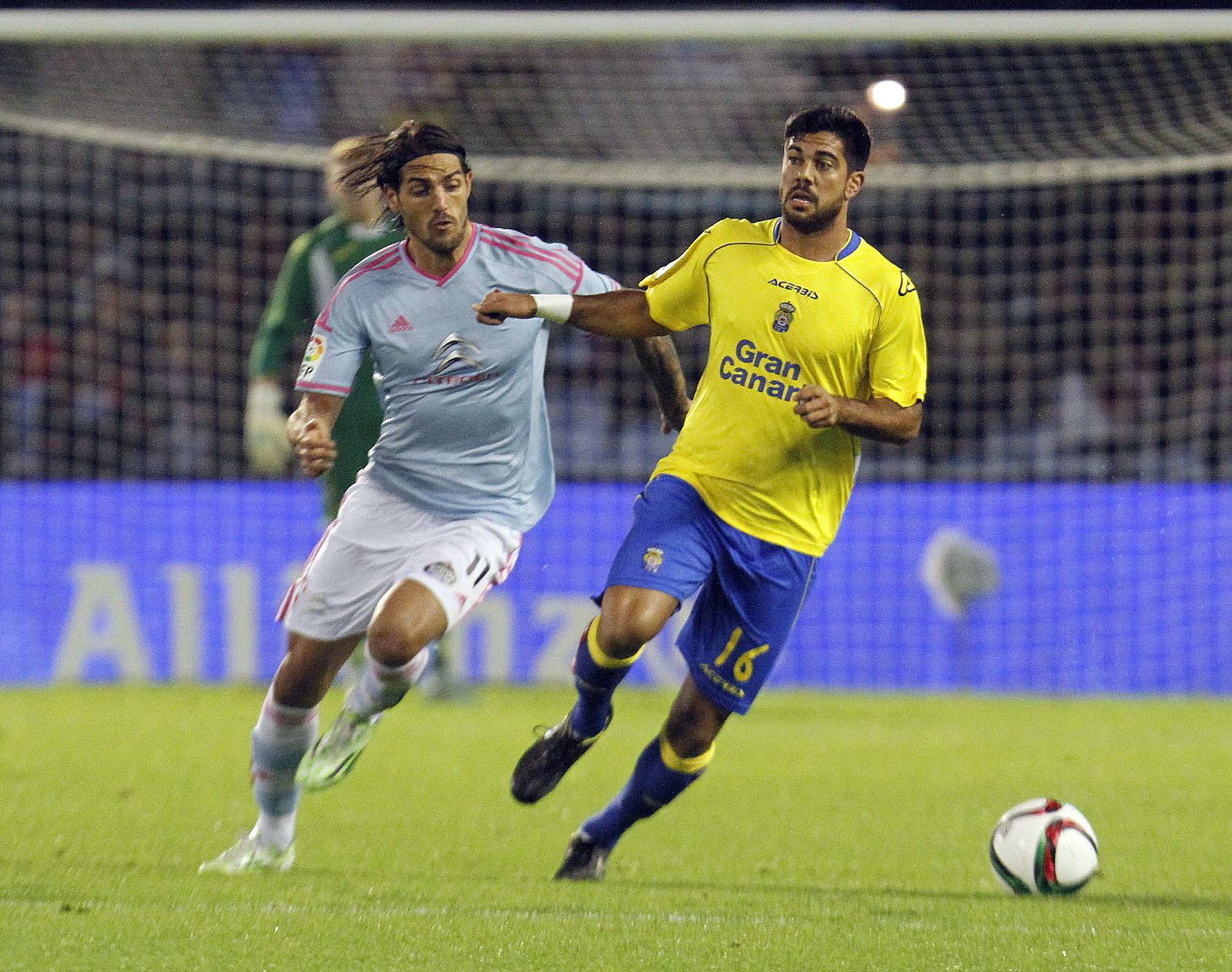 Joaquín Óscar Larrivey (i) y el defensa de Las Palmas Aythami Artiles Oliva luchan por el balón.