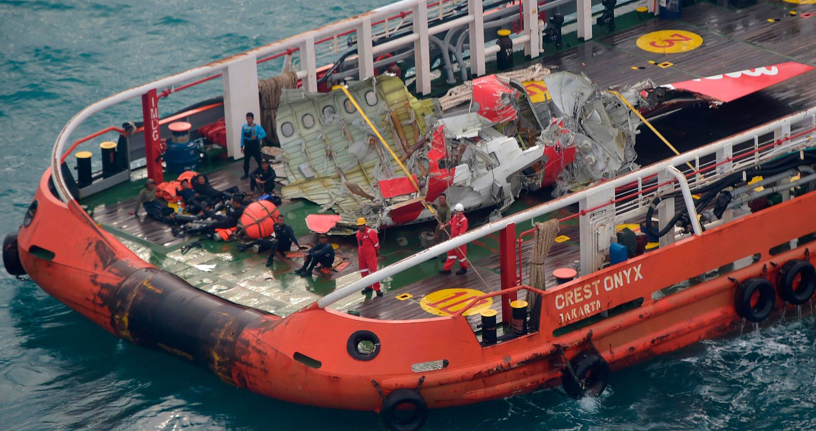 The tail of AirAsia QZ8501 passenger plane is seen on the deck of the rescue ship Crest Onyx after it was lifted from the sea bed, in the Java Sea