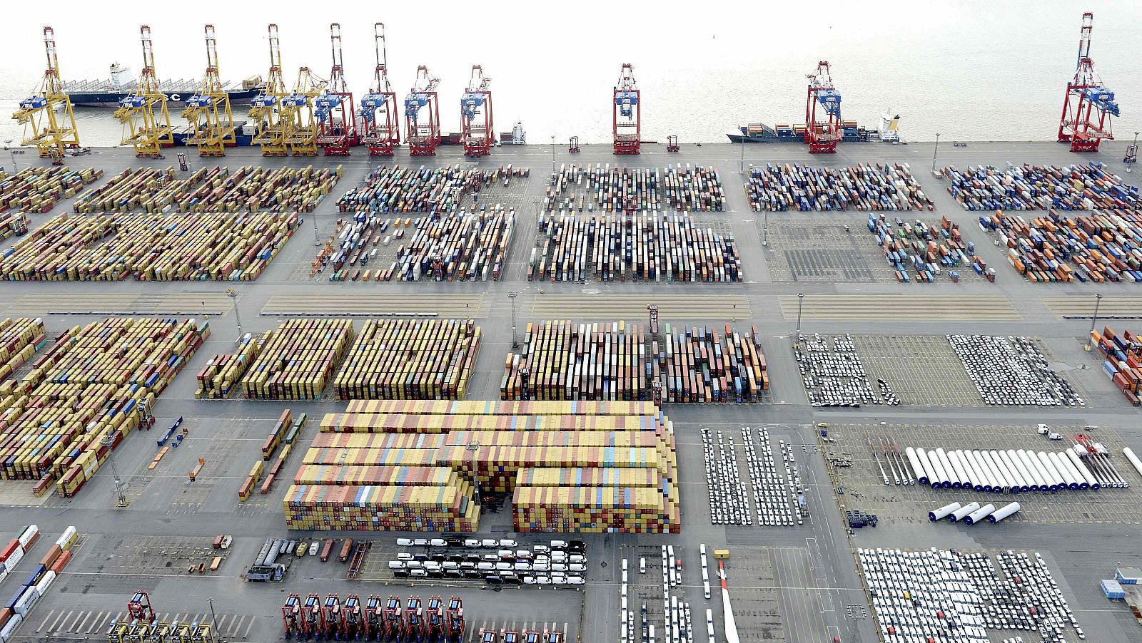 Cars and containers are pictured at a shipping terminal in the harbour of the German northern town of Bremerhaven