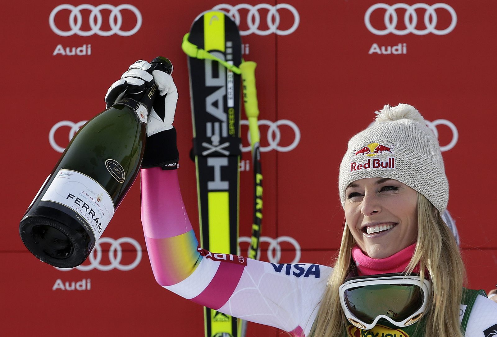 Lindsey Vonn of the U.S. celebrates with champagne on the podium after winning the women's World Cup Super-G skiing race in Cortina D'Ampezzo
