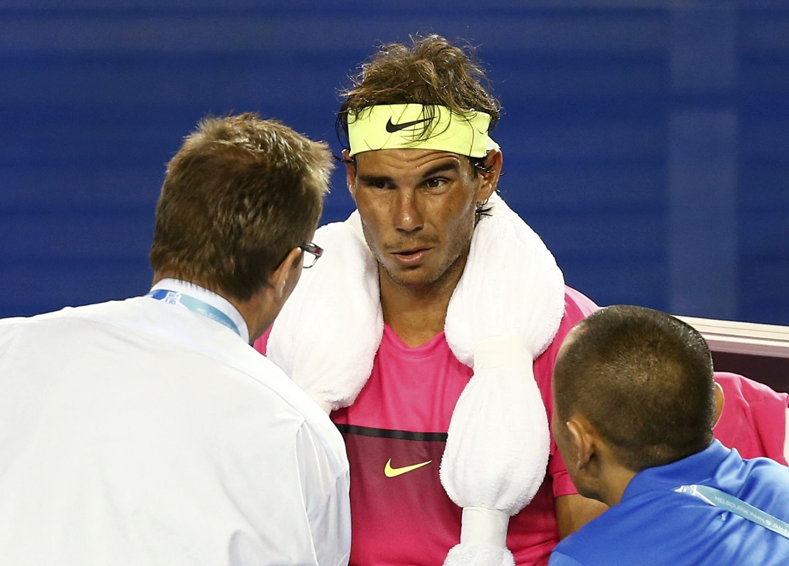 Nadal of Spain speaks with medical staff during his men's singles second round match against Smyczek of the U.S. at the Australian Open 2015 tennis tournament in Melbourne