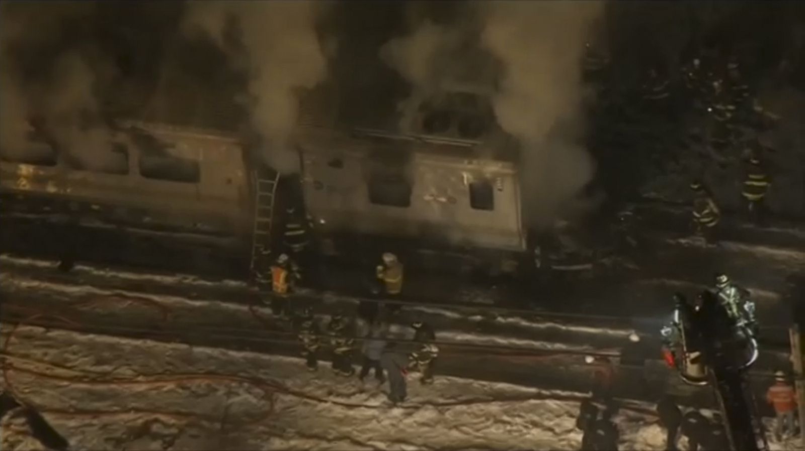 A still image captured from WNBC-TV video shows first responders battling fire on a New York City -Metro-North train following an accident near Valhalla New York