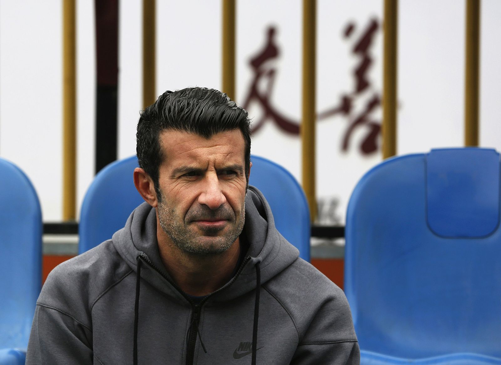 Former Portugal forward Figo watches a Figo Football Academy training session in Guangzhou