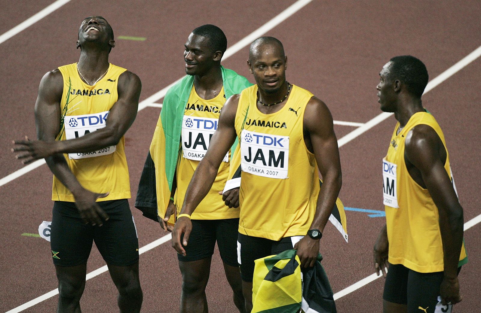 Jamaican sprinters celebrate after placing second in the men's 4x100 metres realy final at the 11th IAAF World Athletics Championships in Osaka