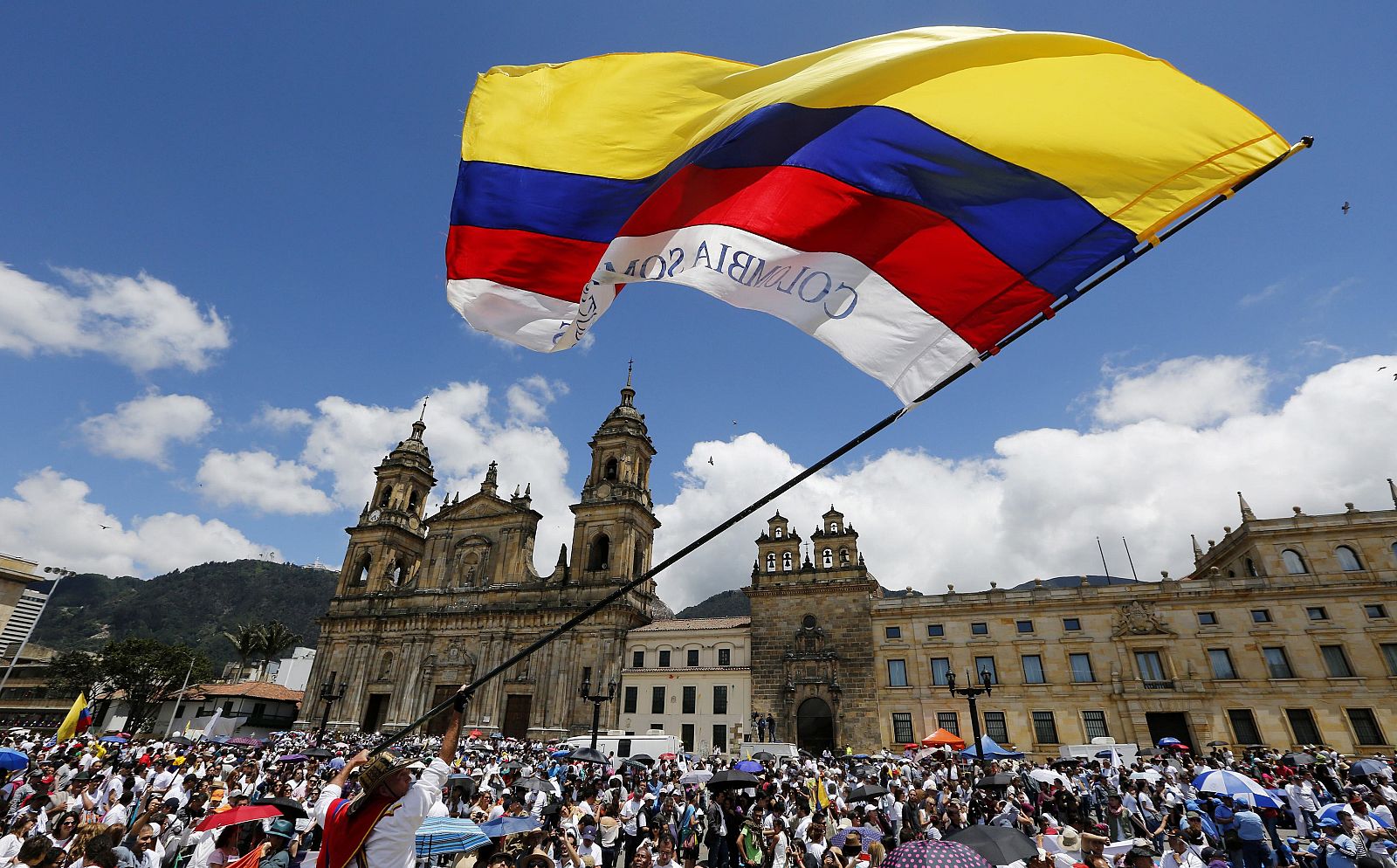 A man waves a national flag during the "March For Life" in Bogota