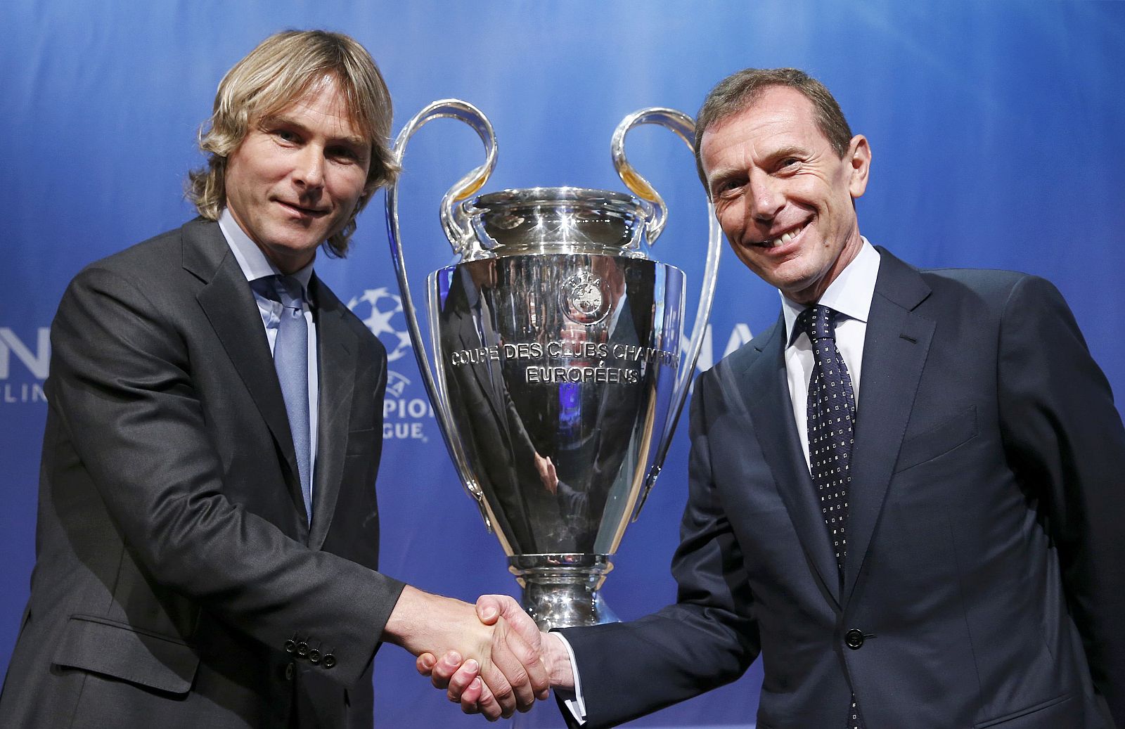 Juventus? ambassador  Nedved shakes hand with Real Madrid's ambassador Butragueno after the draw for the Champions League semi-finals matches at the UEFA in Nyon