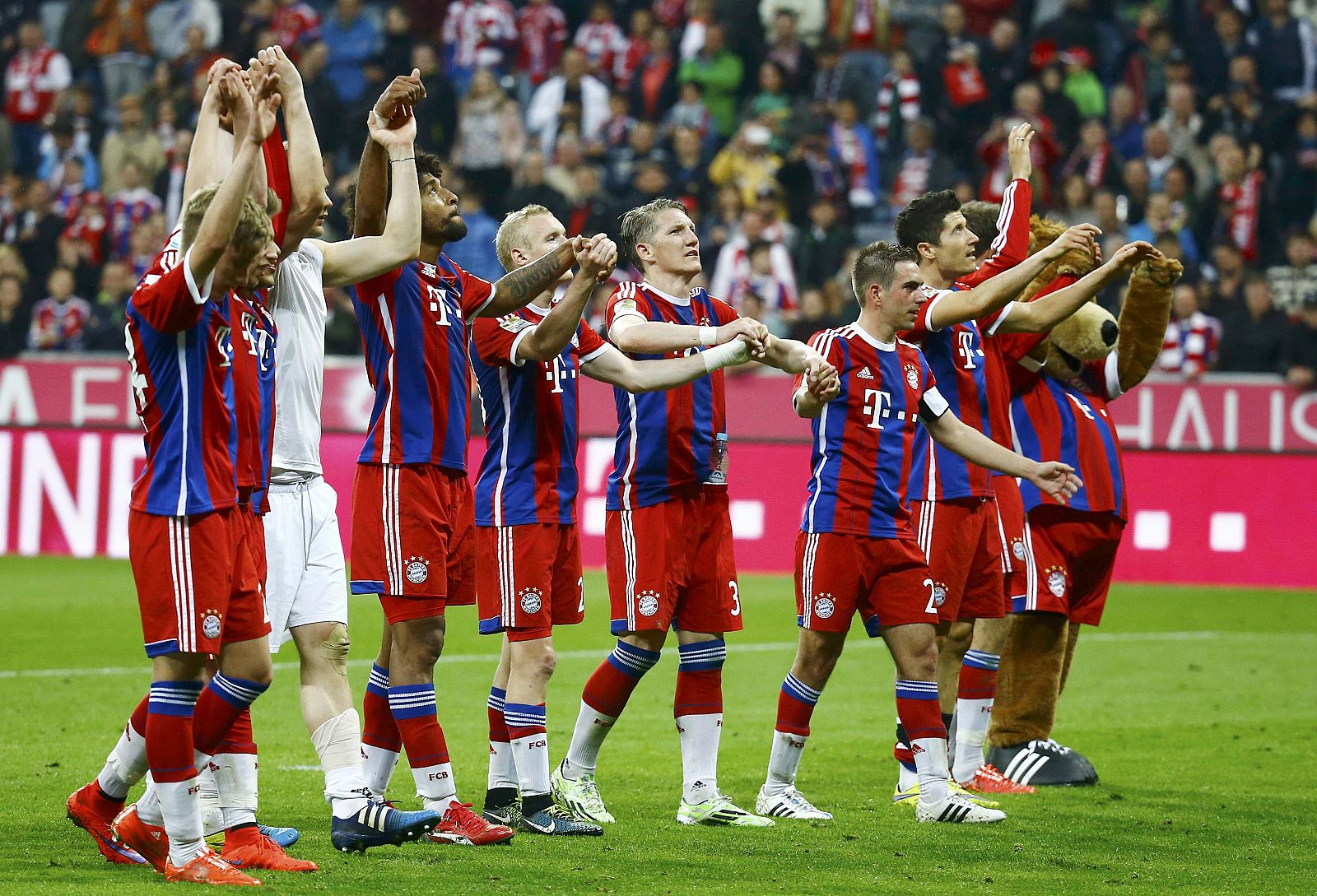 Bayern Munich players acknowledge their fans after winning Bundesliga first division soccer match against Hertha Berlin in Munich
