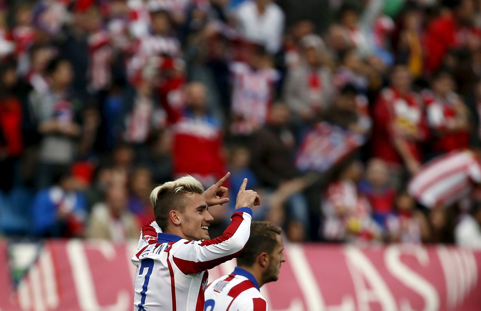 Atletico Madrid's Griezmann celebrates scoring against Elche during their Spanish first division soccer match at Vicente Calderon stadium in Madrid