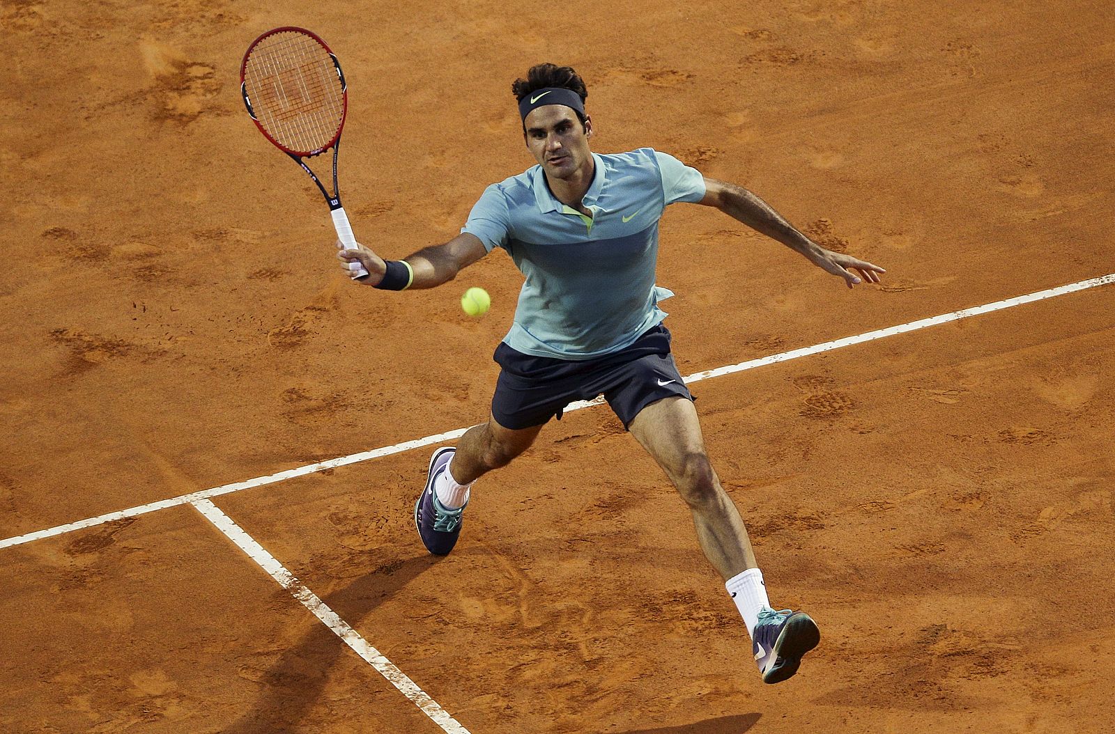 Federer of Switzerland returns the ball to Cuevas of Uruguay during their tennis match at the Rome Open tennis tournament in Rome