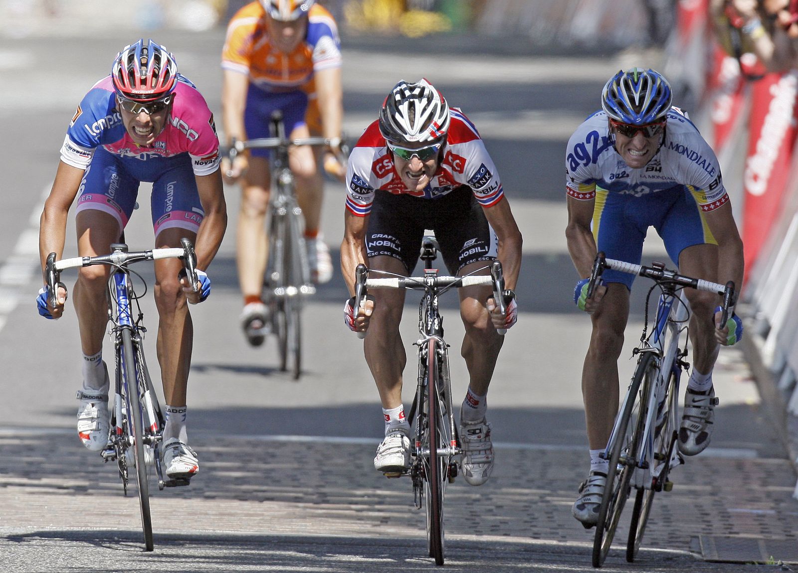Team CSC Saxo Bank rider Arvesen of Norway sprints to the finish line ahead of AG2R team rider Elmiger of Switzerland and Lampre team rider Ballan of Italy after the eleventh stage of the 95th Tour de France cycling race between Lannemezan and Foix