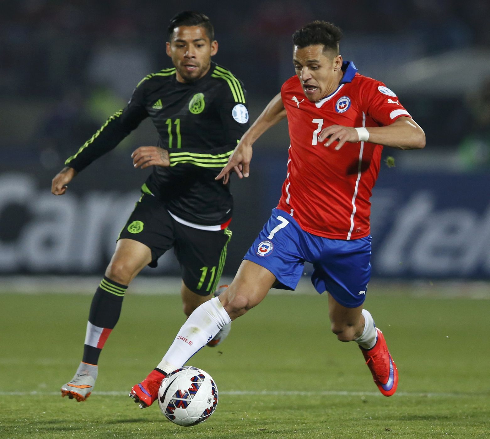 Chile's Sanchez drives the ball past Mexico's Aquino during their first round Copa America 2015 soccer match at the National Stadium in Santiago