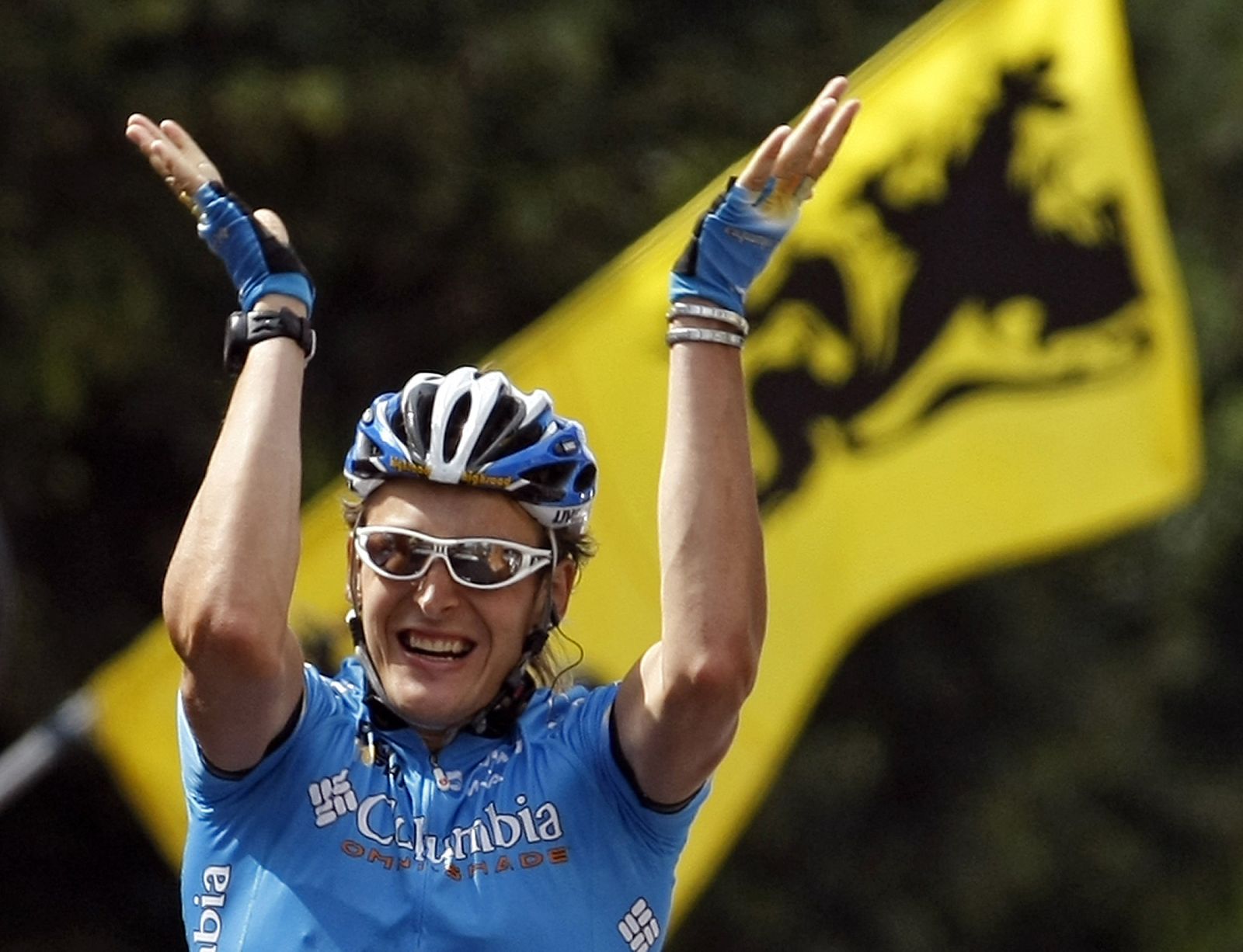 Team Columbia rider Burghardt of Germany holds up his arms as he wins the eighteenth stage of the 95th Tour de France cycling race between Bourg-d'Oisans and Saint-Etienne