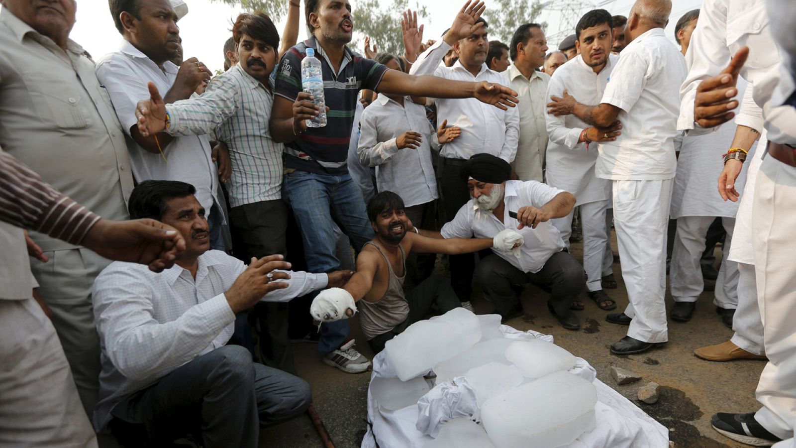 Con las manos vendadas por las quemaduras, el padre de los dos niños asesinados muestra los cuerpos de sus hijos