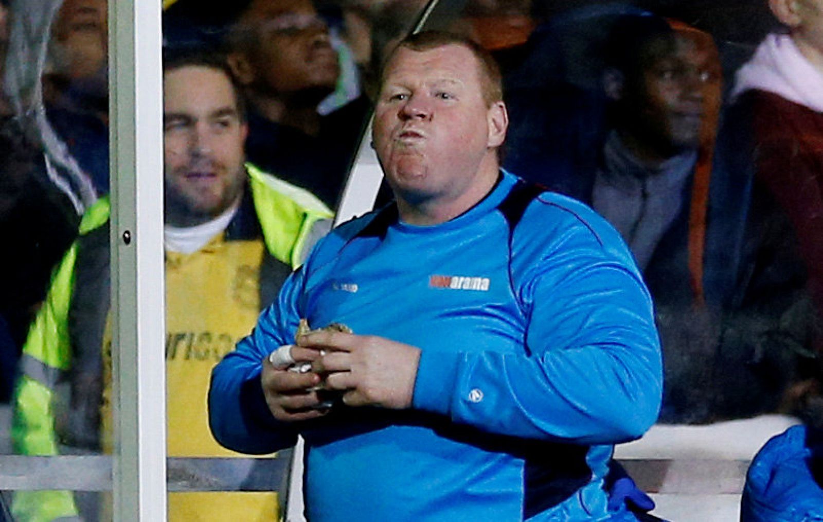 Wayne Shaw eats a pie during the match