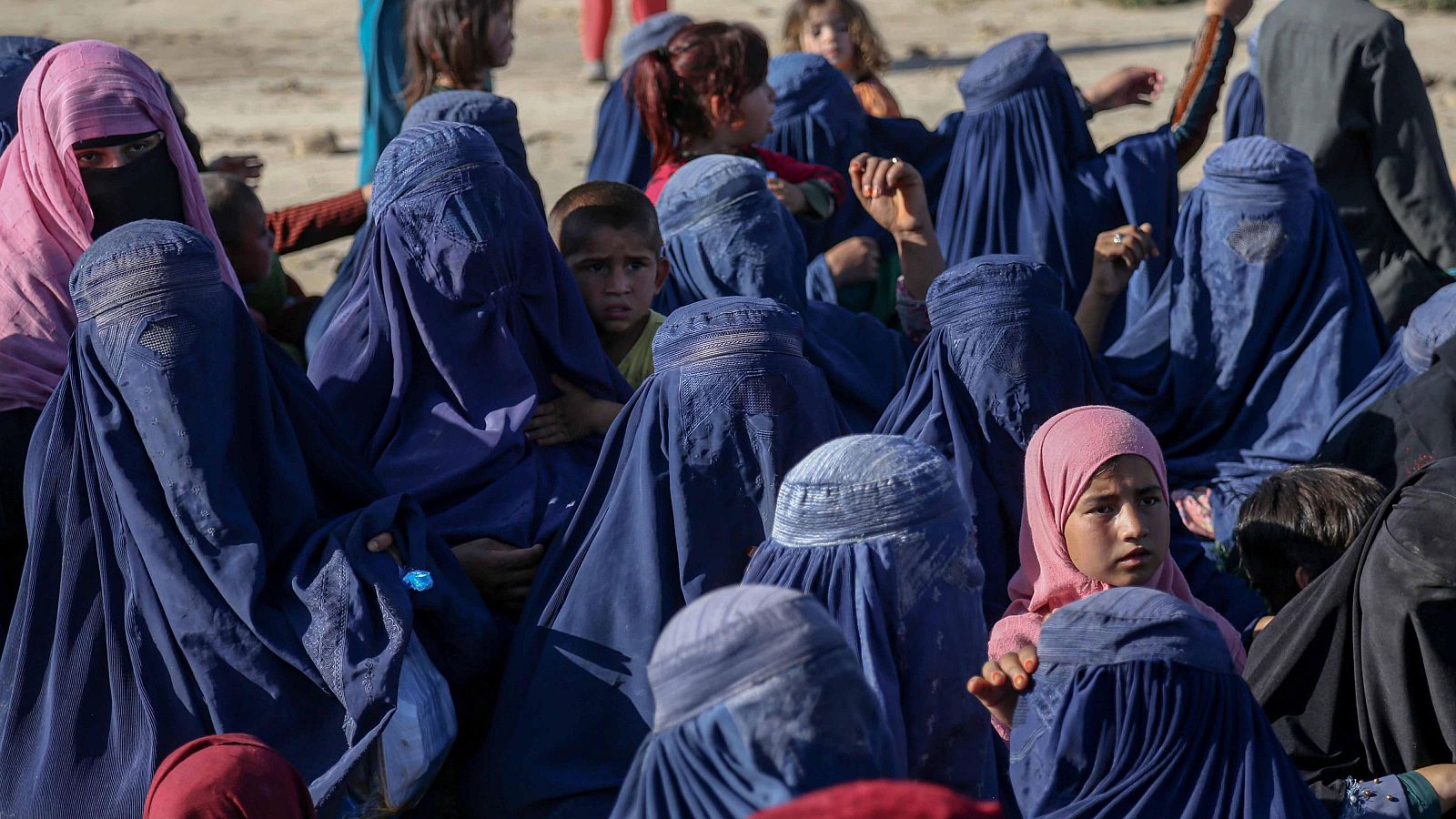 People affected by floods receive food in Falol village