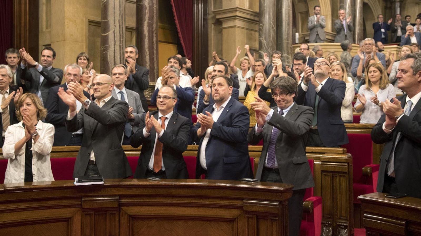 El presidente de la Generalitat, Carles Puigdemont (2d), mira a la presidenta del parlament Carme Forcadell, en un gesto de agradecimiento tras aprobar la Ley de Transitoriedad Jurídica.