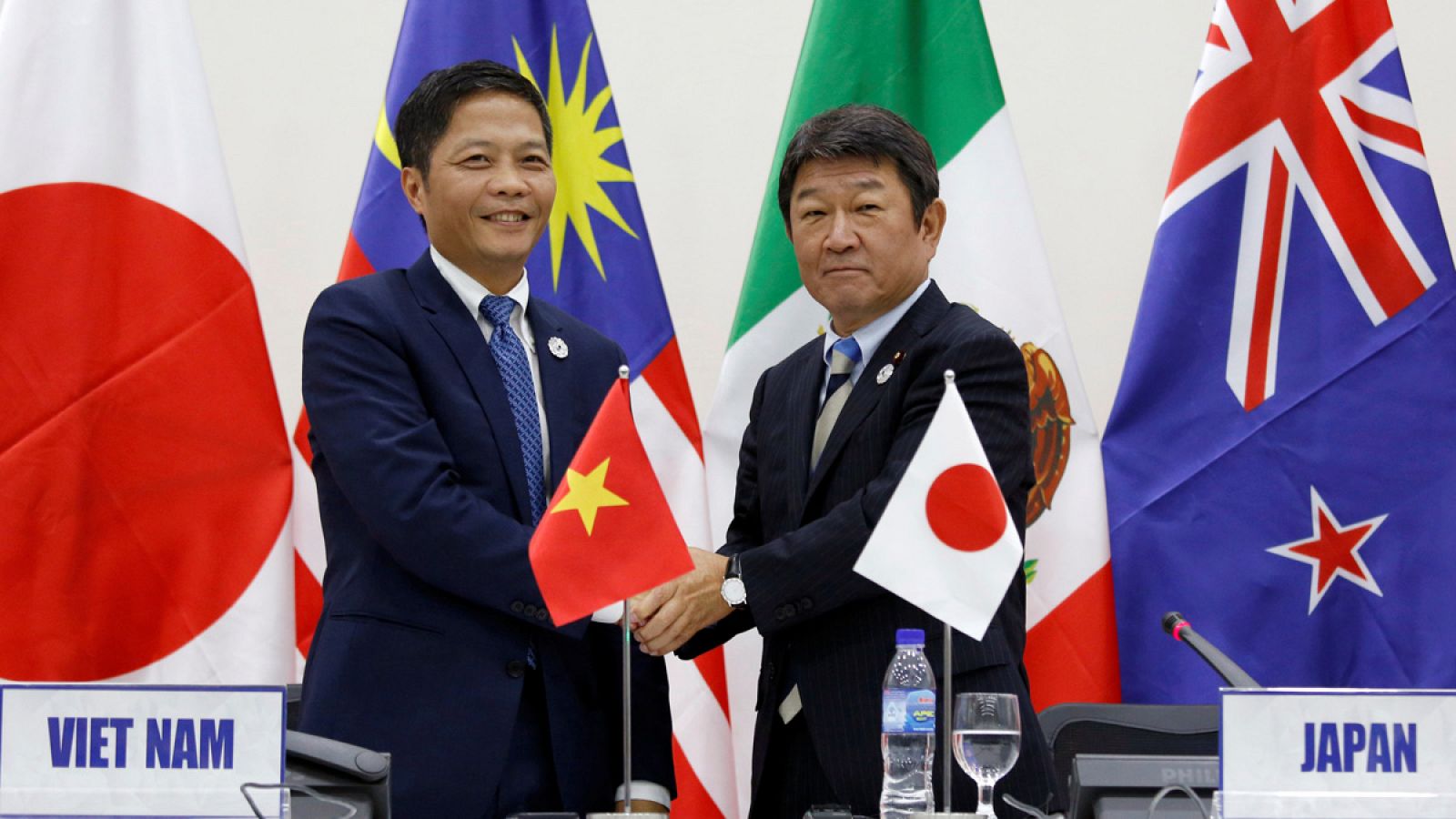 El ministro de Industria y Comercio de Vietnam, Tran Tuan Anh, y el titular de Revitalización Económica de Japón, Toshimitsu Motegi, estrechan su mano