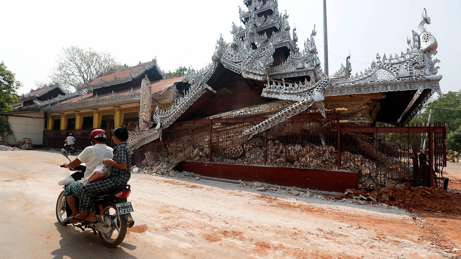Una motocicleta pasa junto a la pagoda Maha Myat Muni, derrumbada en Mandalay, el 2 de abril de 2025.