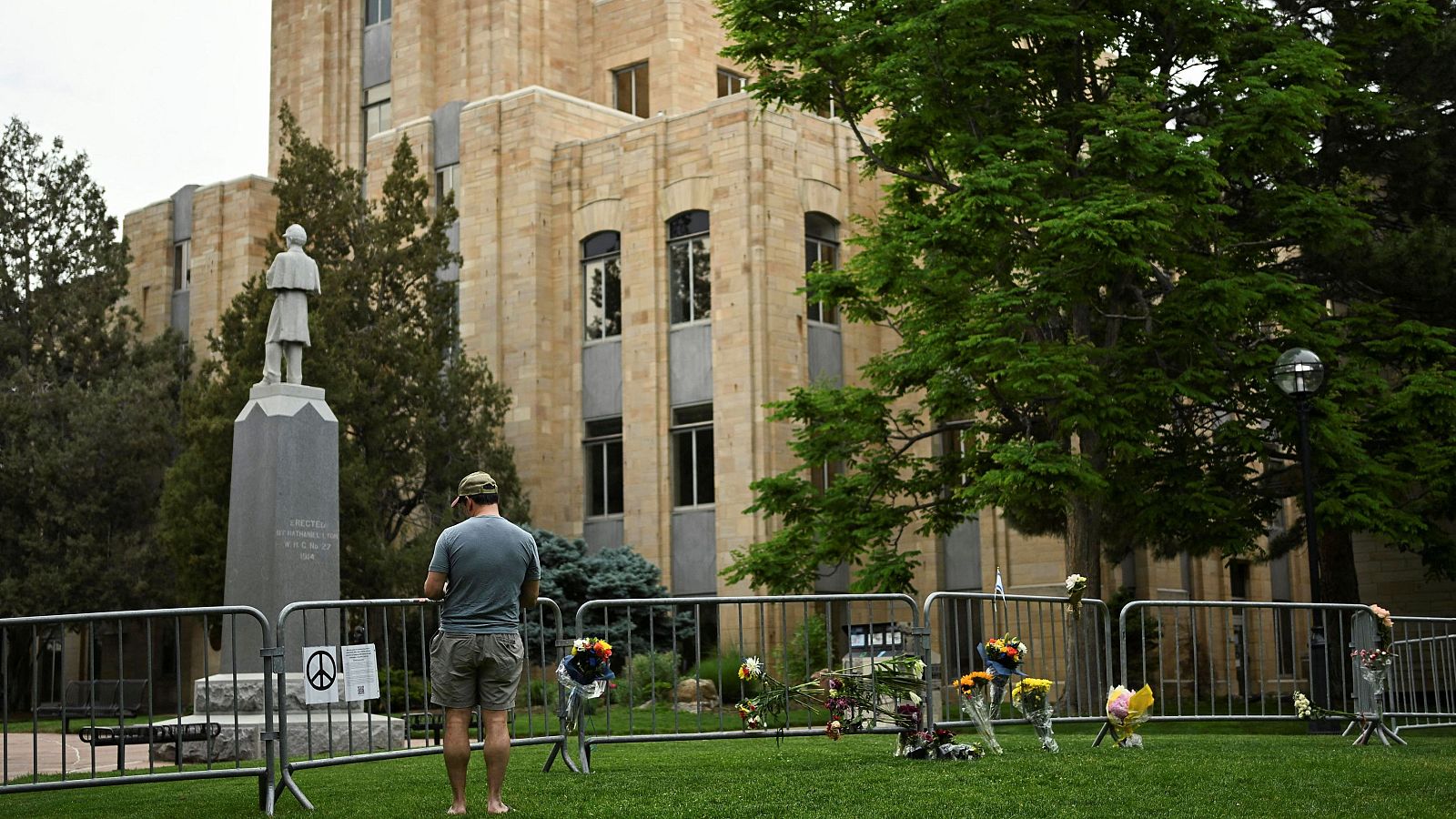 Un hombre lee una nota en apoyo a las víctimas del ataque en Colorado, EE.UU.