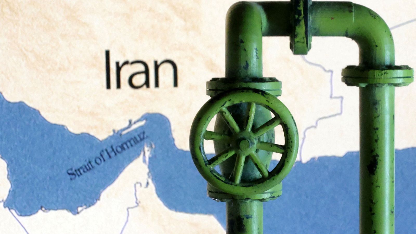 Tubería verde con válvula sobre mapa del Estrecho de Ormuz e Irán. Simboliza el control sobre el flujo de recursos en la región.