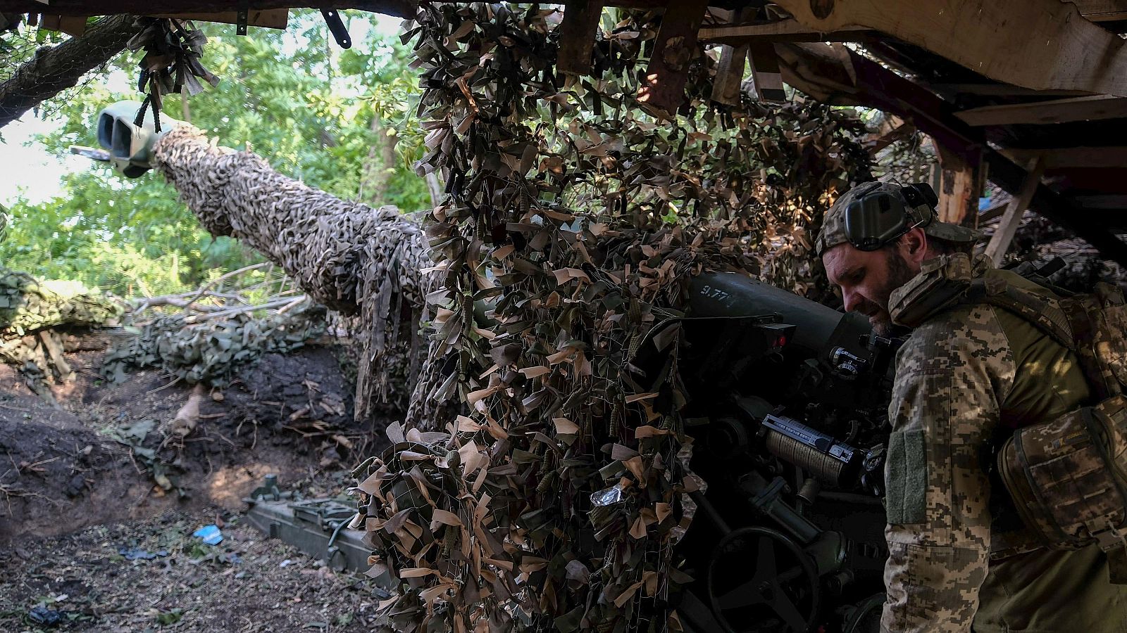 Militares ucranianos se preparan para disparar un obús hacia las posiciones rusas en la línea del frente en Donetsk