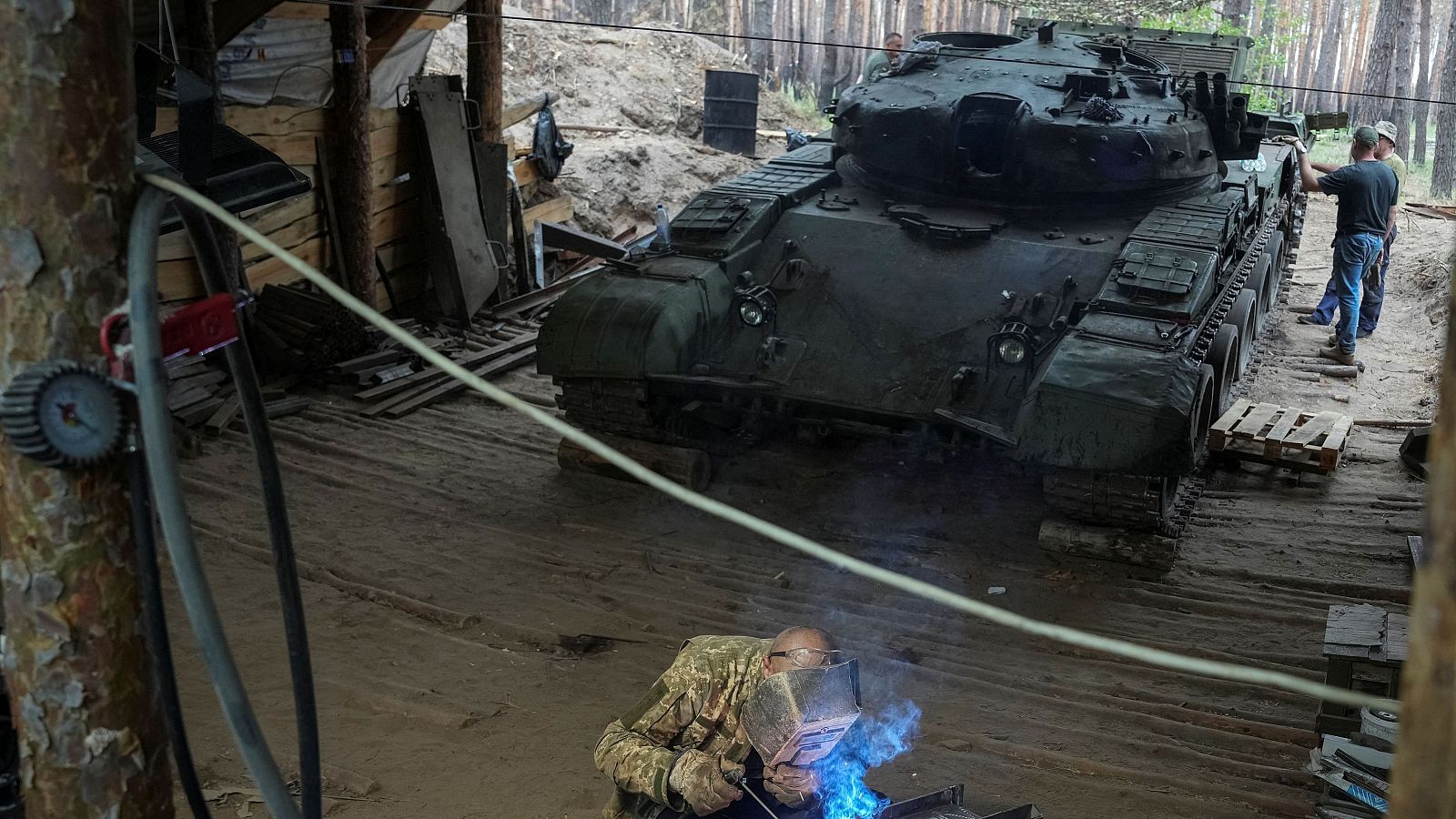 Un soldado de la 57ª Brigada de Infantería Motorizada Separada de las Fuerzas Armadas de Ucrania repara un tanque