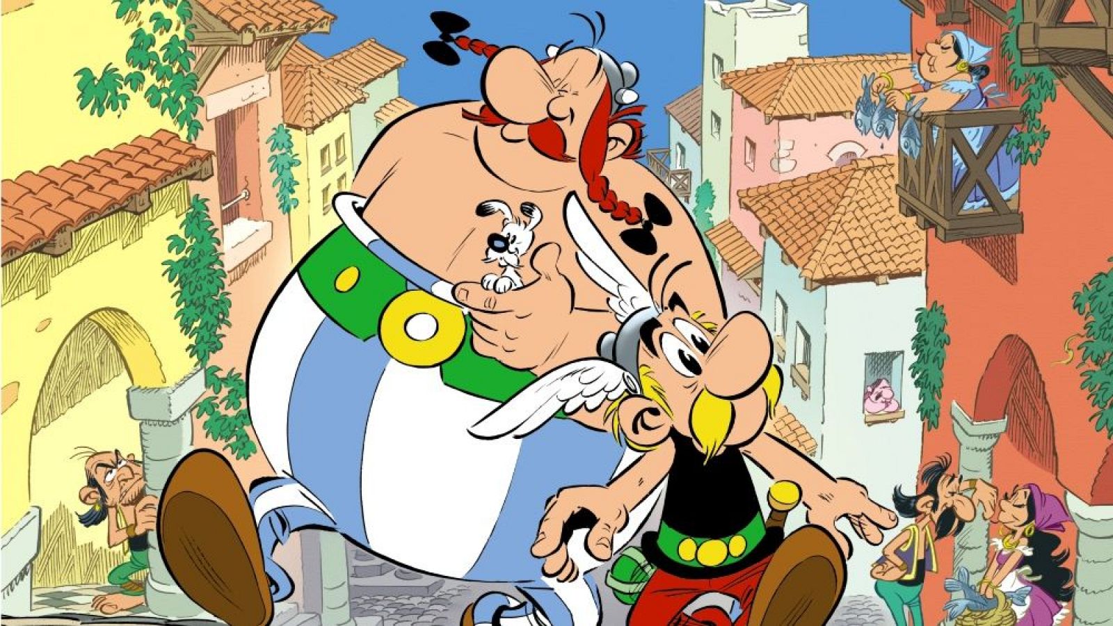 En la portada de un cómic, se destacan dos personajes principales: un hombre pequeño con casco y bigote, y otro corpulento con trenzas, que sostiene un perro. Detrás, se observa un pueblo con edificios de tejados rojos.