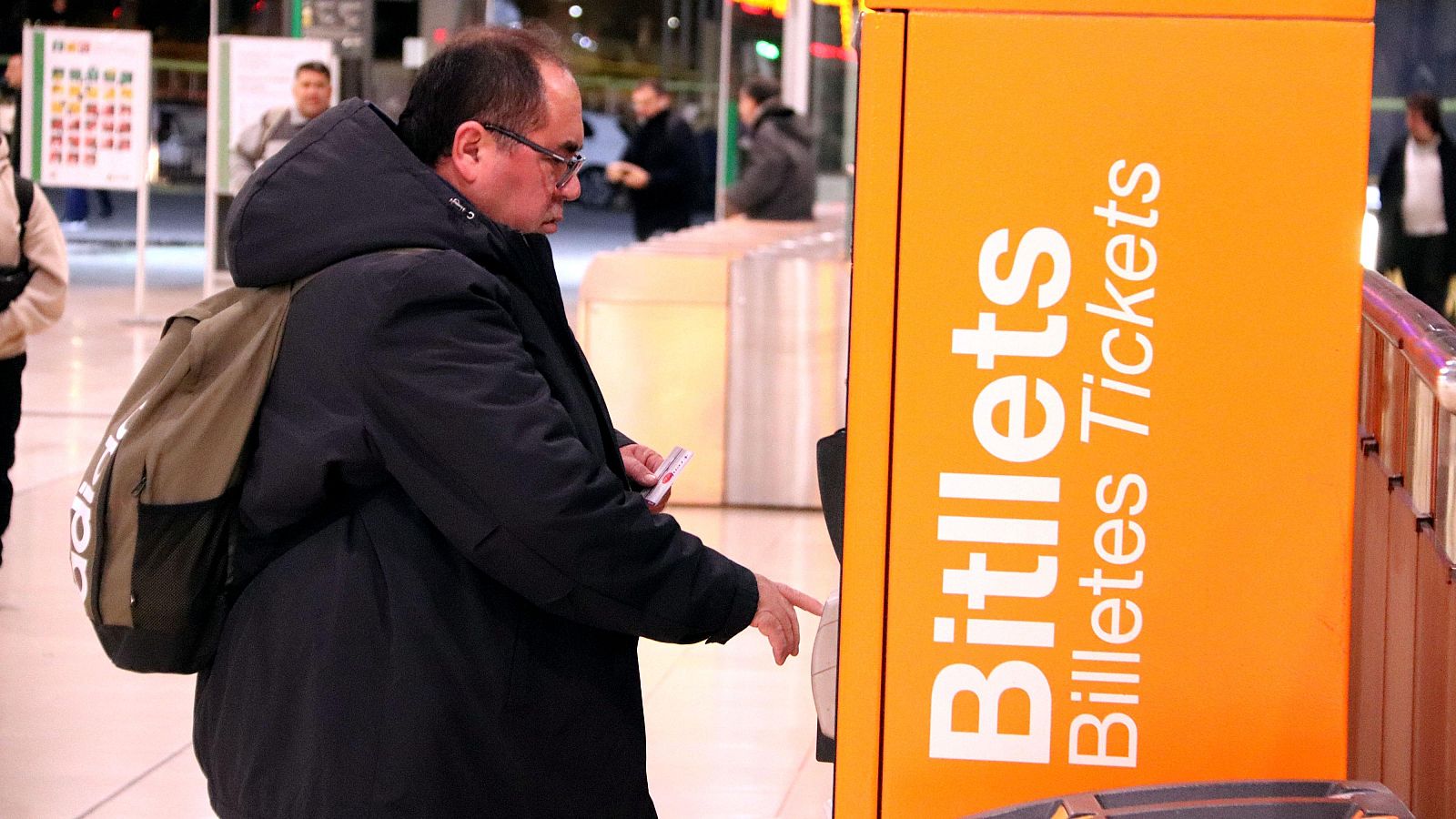 Un viatger de Rodalies compra un bitllet de tren a les màquines de venda automàtiques a l'estació de Sants  (ACN | Gerard Escaich Folch)