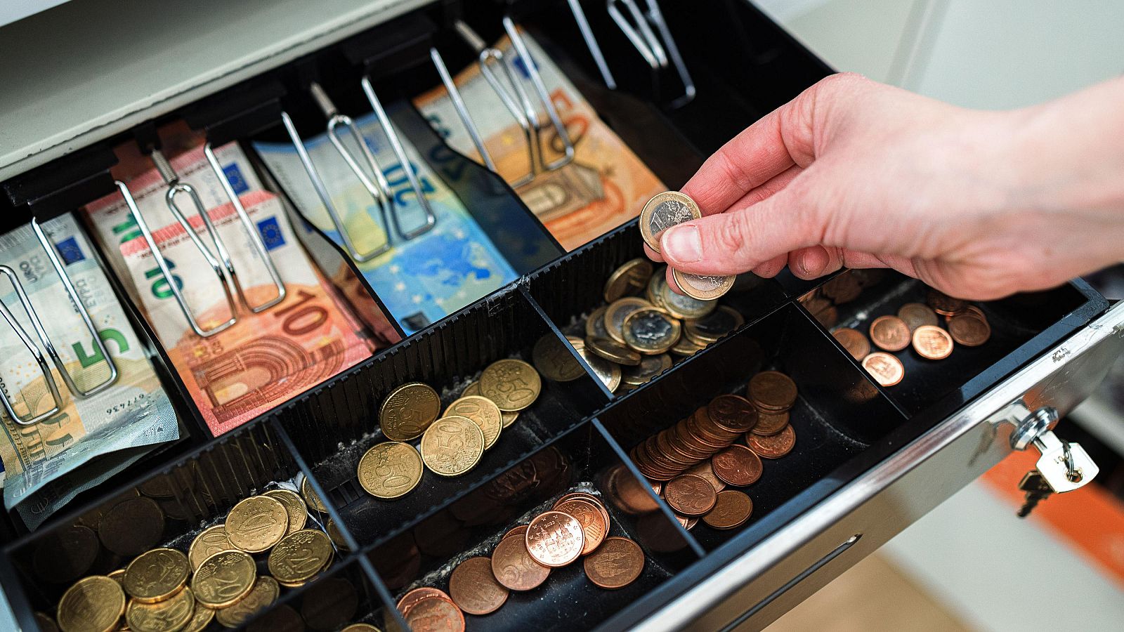 Caixa d'un establiment amb bitllets i monedes d'euro