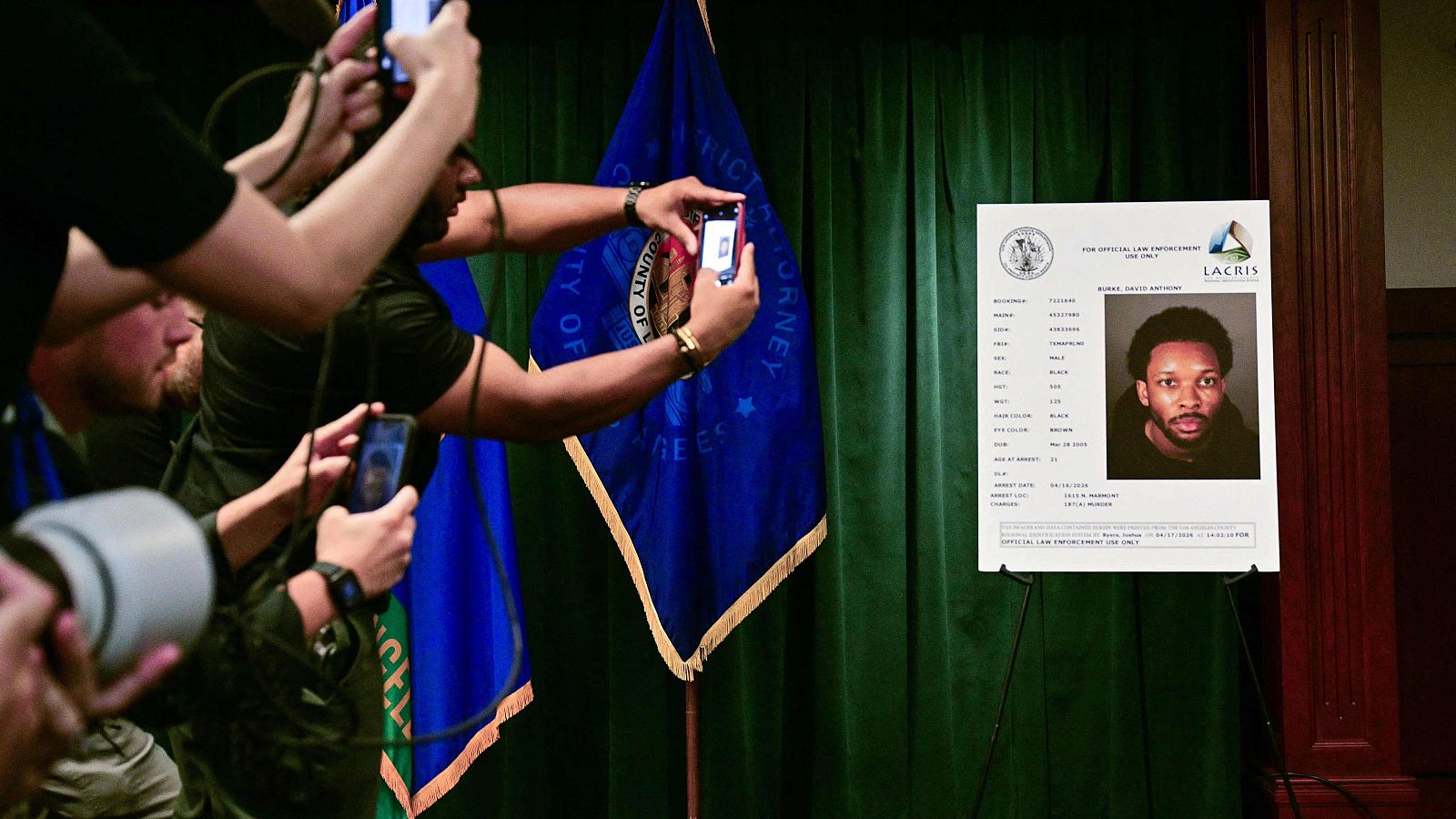 Los periodistas toman fotos de una foto de reserva de Anthony David Burke, conocido como D4vd, antes del inicio de una conferencia de prensa sobre el caso contra D4vd en el Salón de la Justicia de Los Ángeles