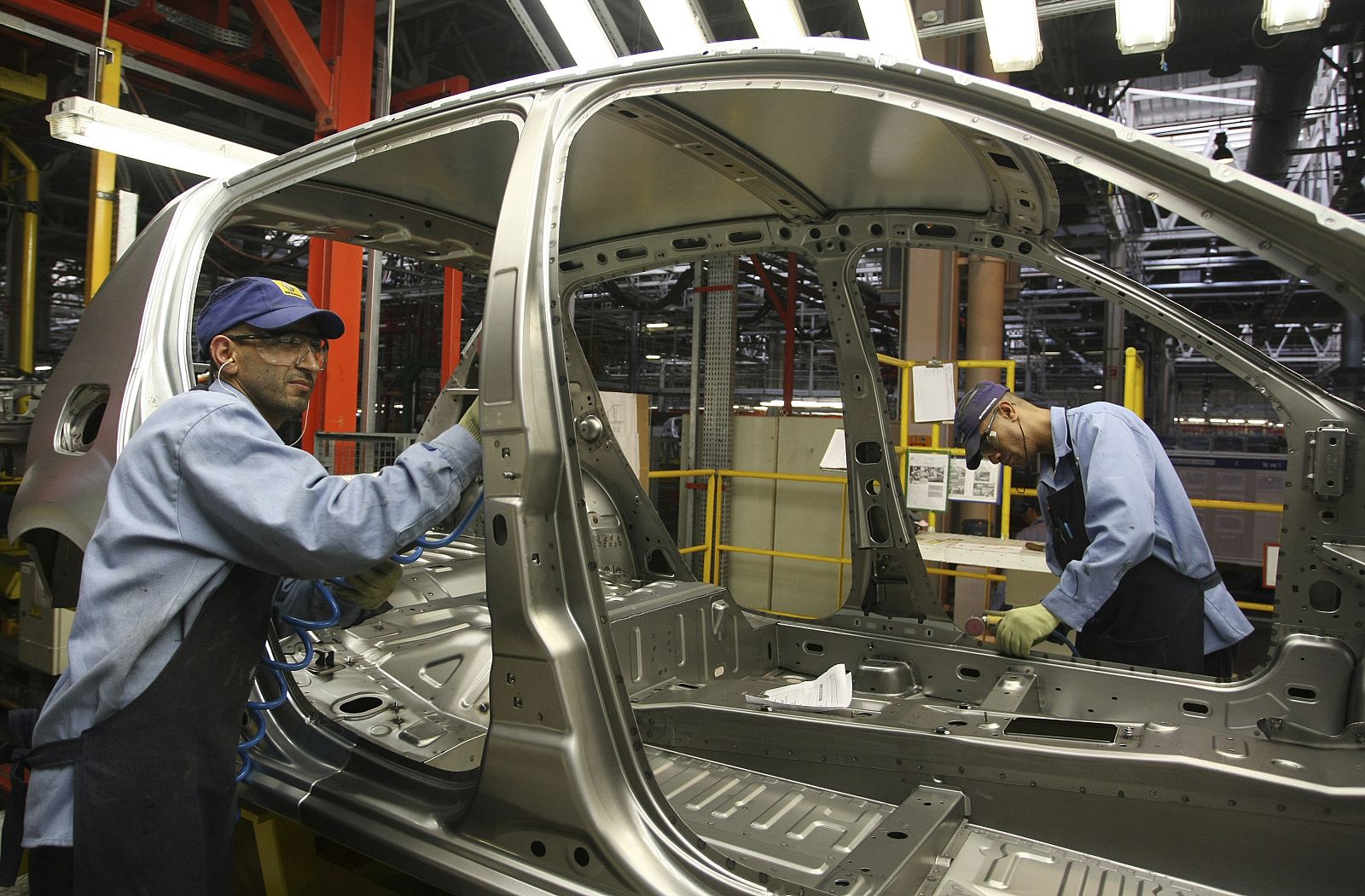 Workers assemble a car at the Renault automobile manufacturing plant in Curitiba