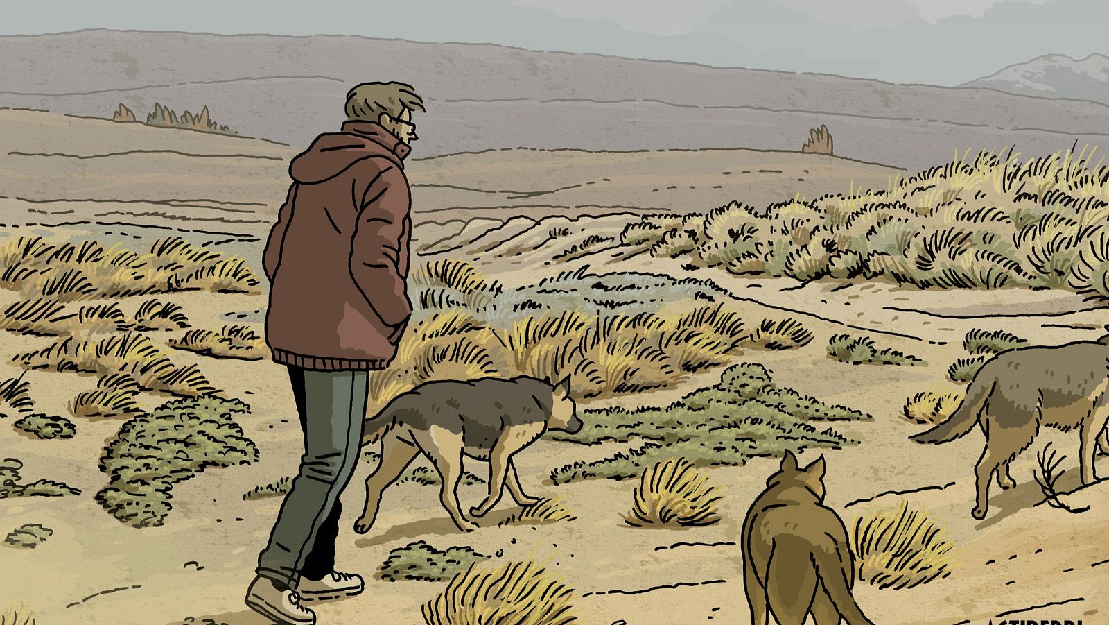 Paco Roca camina en un paisaje desolado con tres perros. Viste chaqueta marrón rojizo y gafas. El entorno es árido con vegetación seca y colinas al fondo.