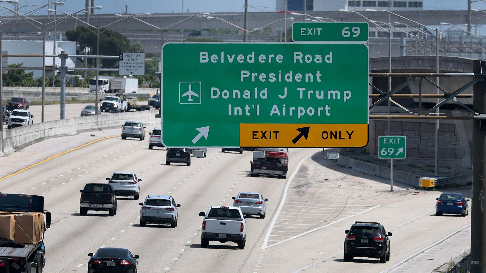 Salida 69 hacia Belvedere Road y Aeropuerto Internacional Presidente Donald J. Trump. Carril derecho solo para salir. Tráfico en autopista.