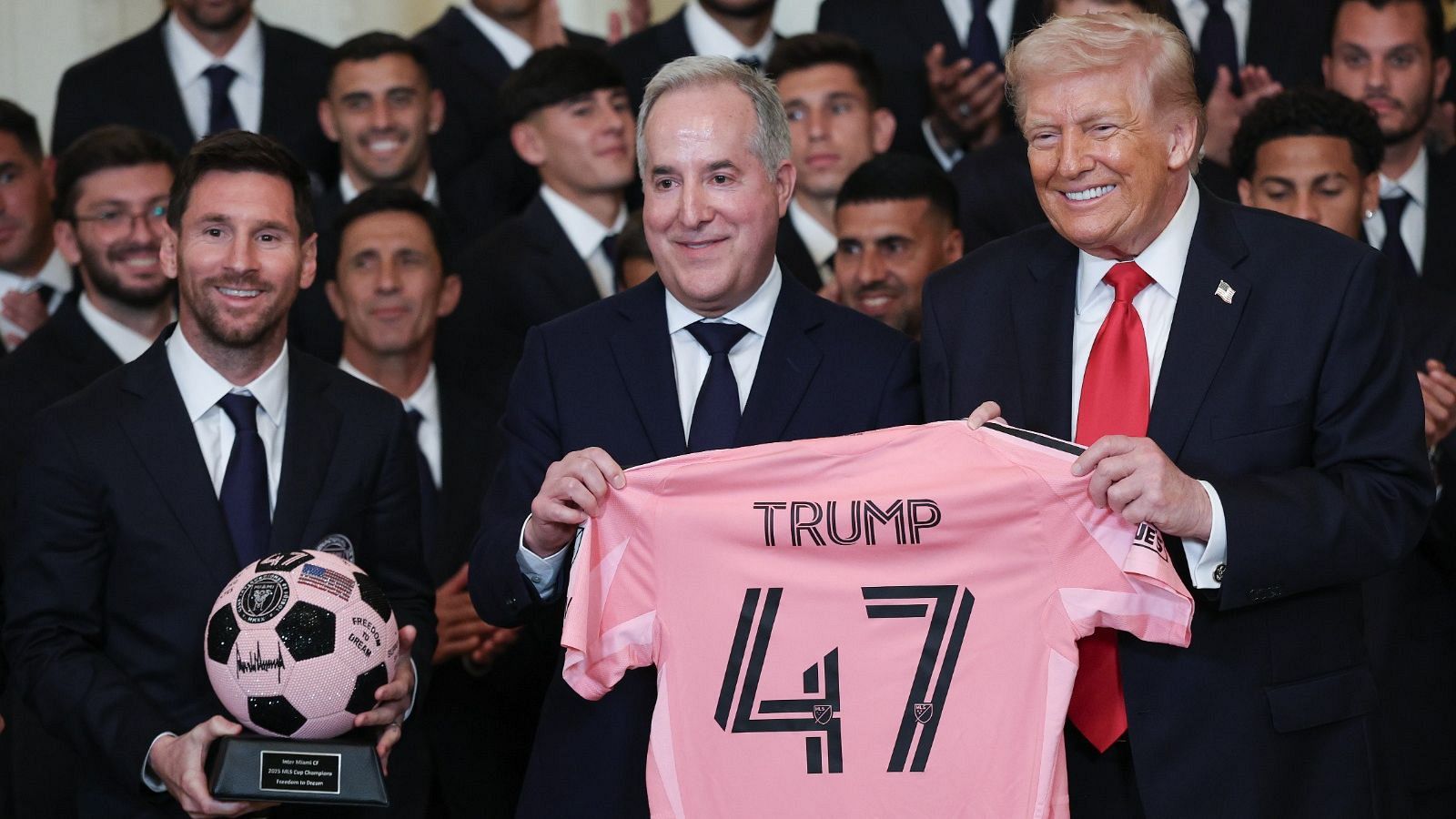 Donald Trump, Jorge Mas y Lionel Messi posan con una camiseta de fútbol rosa y negra con "TRUMP 47" y un trofeo con el logo del Inter Miami CF.
