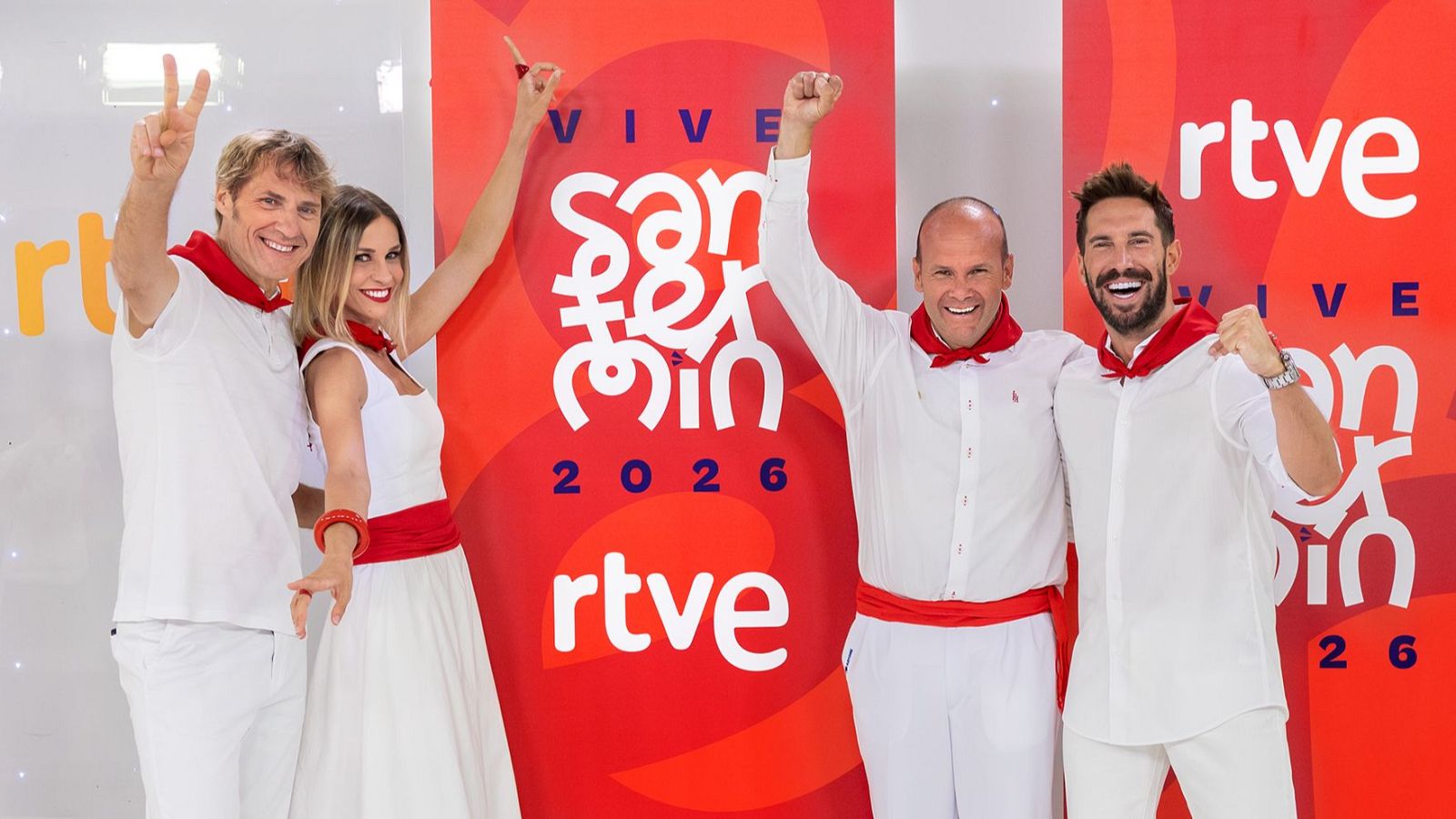 Julian Iantzi, Ana Prada, Teo Lázaro y Egoitz Txurruka, presentadores de 'VIVE San Fermín 2026' de RTVE, posan con vestimenta blanca y roja, celebrando frente a un fondo con el texto 'VIVE San Fermín 2026' y el logo de RTVE.