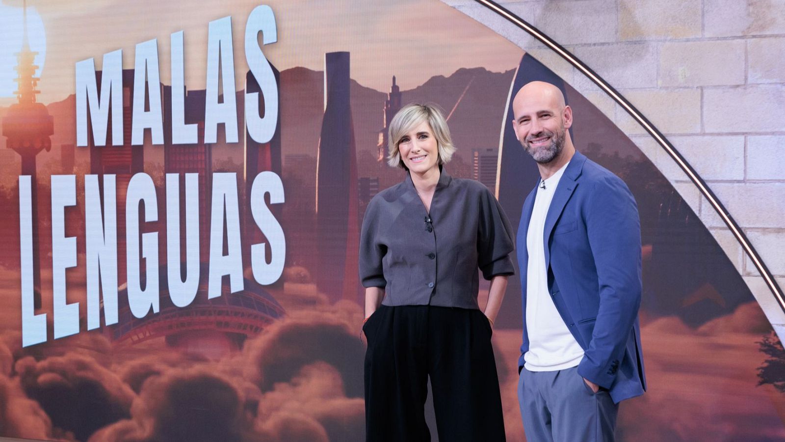 Ane Ibarzabal y Gonzalo Miró, presentadores de "Malas Lenguas", posan con un fondo urbano y el título del programa.