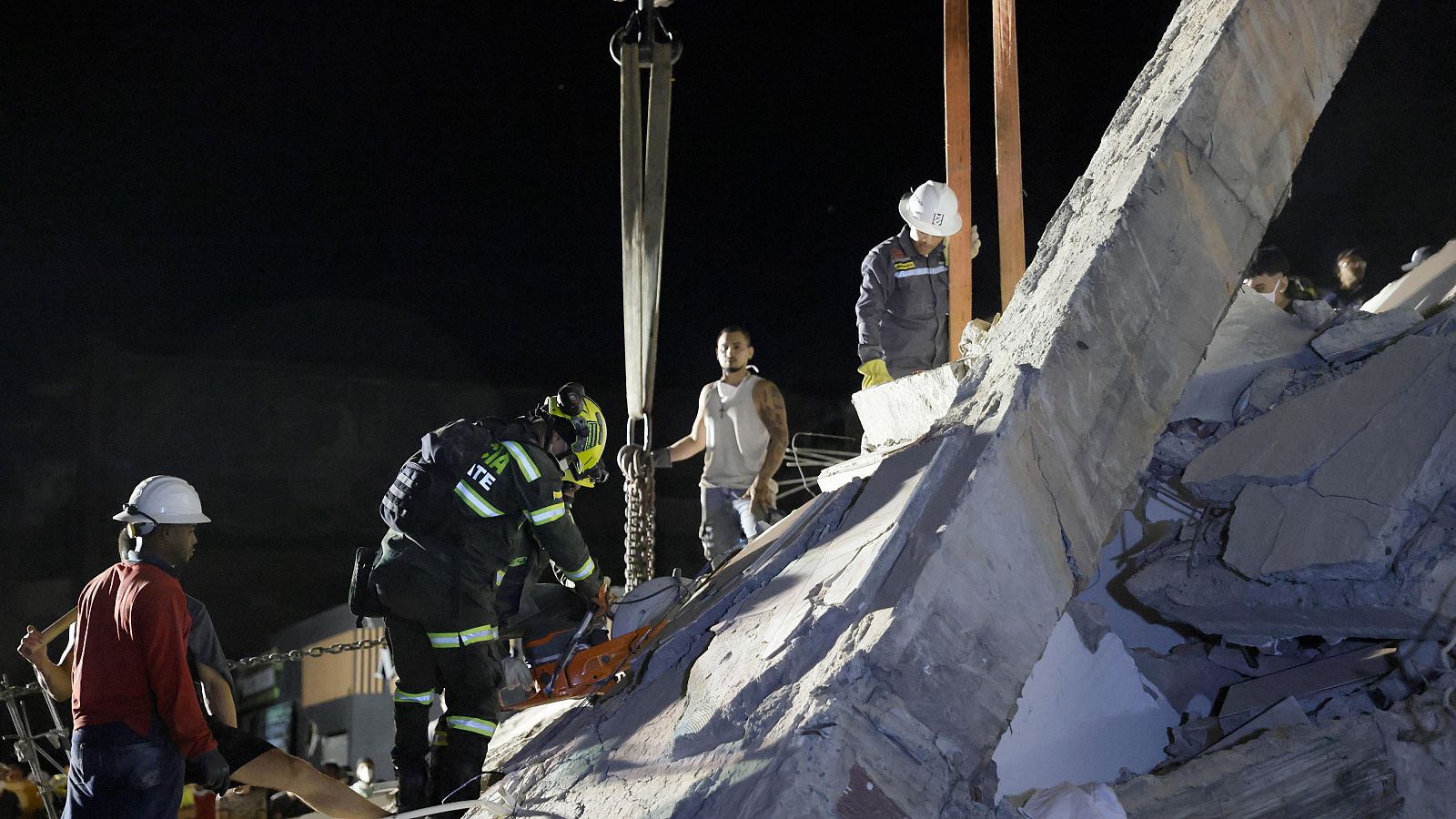 Un grupo de trabajadores busca supervivientes entre los escombros de los edificios derruidos por el terremoto de Colombia.