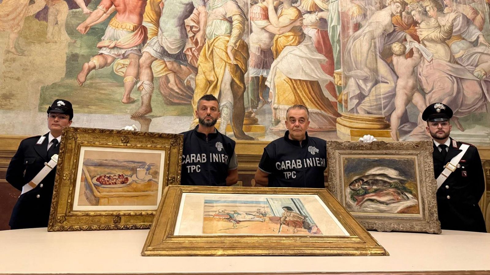 Agentes de la unidad especializada en protección del patrimonio artístico (Carabinieri TPC) posando junto a valiosas obras recuperadas de Paul Cézanne (izda.), Pierre-Auguste Renoir (dcha.) y Henri Matisse.