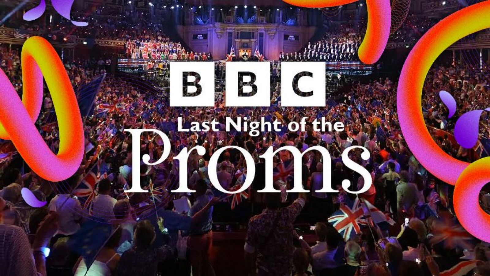 Vista panorámica de un auditorio lleno de gente celebrando el "Last Night of the Proms" con banderas y confeti, con el logo de la BBC visible.